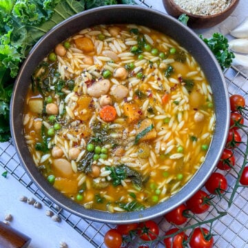 overhead shot looking into a big bowl of hearty beans and kale soup