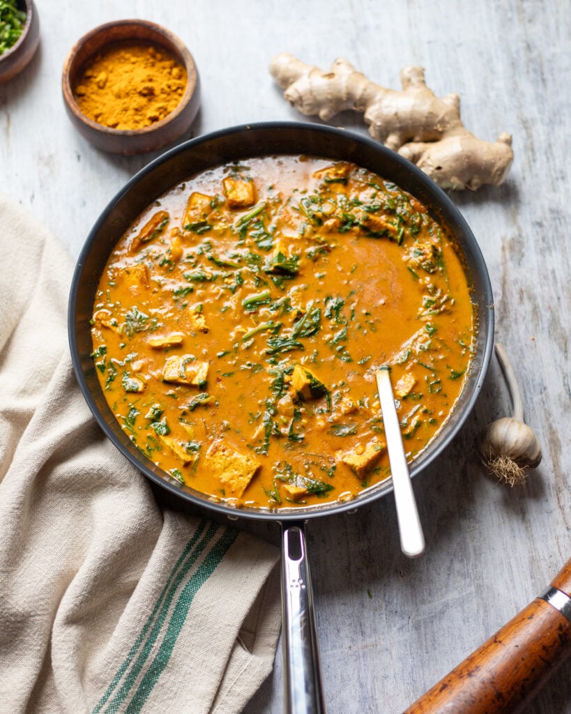 overhead view of a skillet filled with saag tofu curry