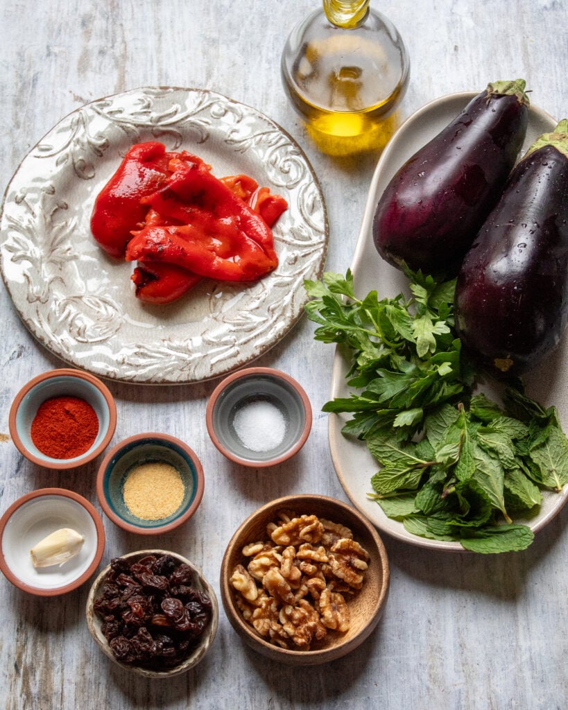 ingredients laid out in small bowls for eggplant salad