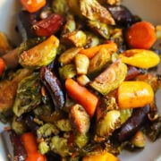 close up view of maple brussels sprouts and carrots glazed with garlic, ginger and soy