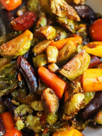 close up view of maple brussels sprouts and carrots glazed with garlic, ginger and soy