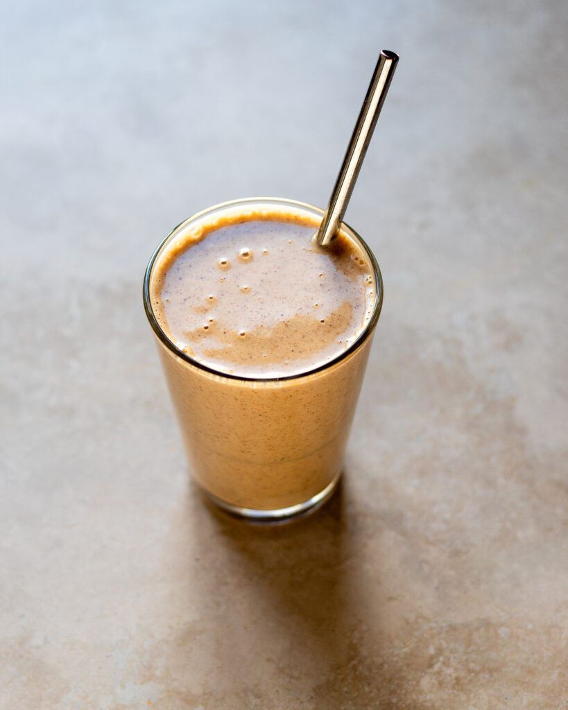 A Cinnamon Almond Vegan Protein SMoothie in a glass