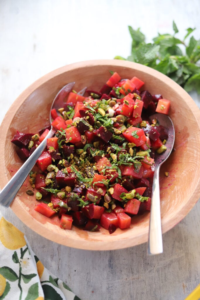 overhead view of a beet salad in a wooden bowl