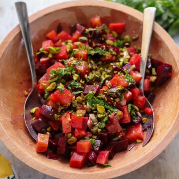 overhead view of a colorful beet salad in a wooden bowl