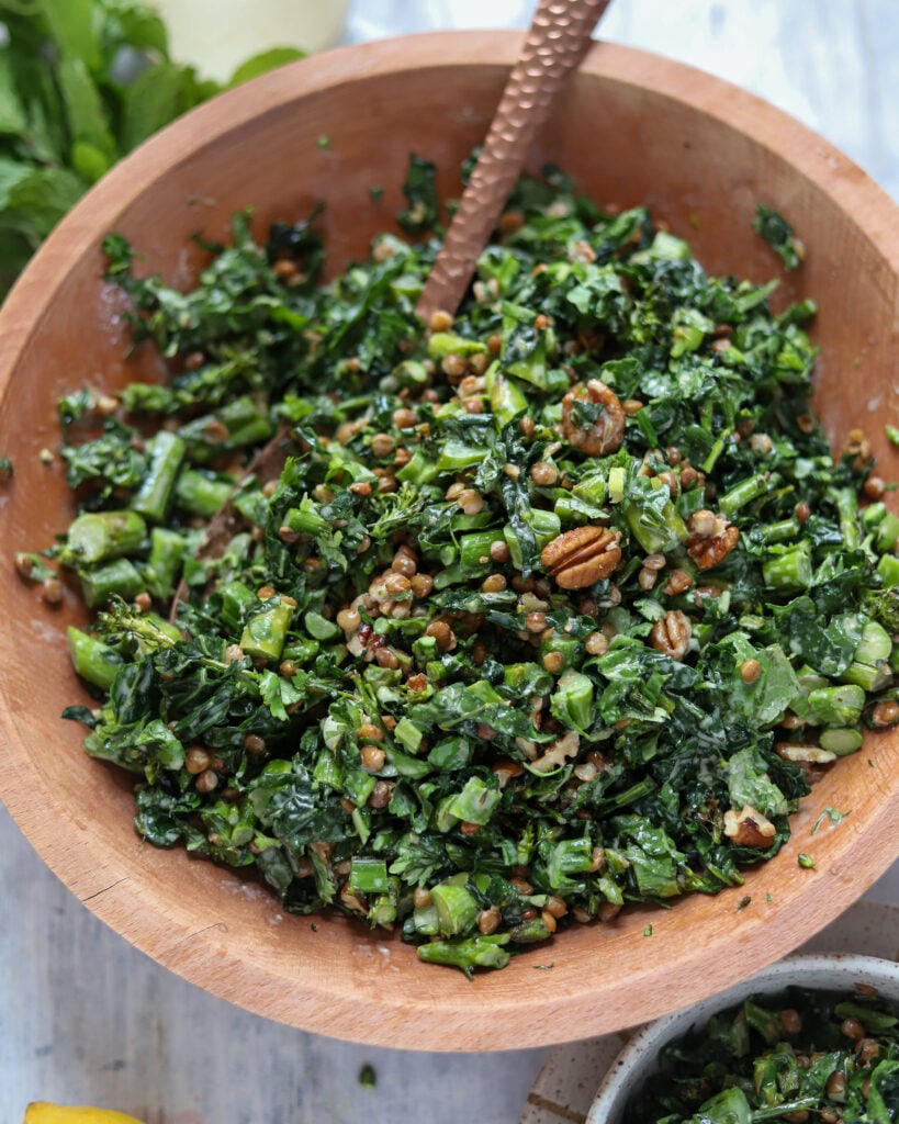 overhead view of big wooden bowl filled with chopped roasted asparagus and lentil salad.