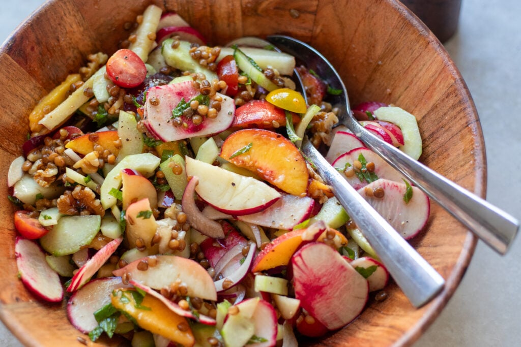 close up of summer peach sale with lentils, salad turnips, onions, nectarines and cucumbers
