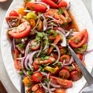 close up of simple tomato and onion salad on a platter