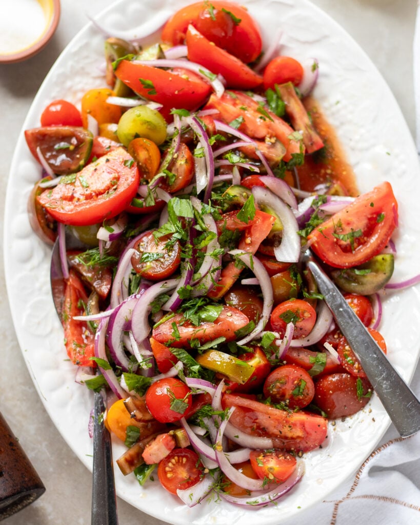 close up of simple tomato and onion salad on a platter