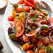 closeup view of a summer tomato and onion salad with fresh herbs